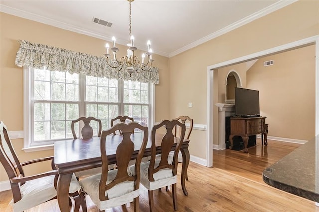 656 Deerwood Way, Evans, GA 30809 - dining room featuring a chandelier, light wood-style flooring, crown molding, and baseboards
