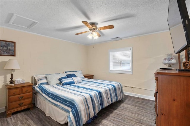 bedroom with ceiling fan, dark hardwood / wood-style flooring, and a textured ceiling