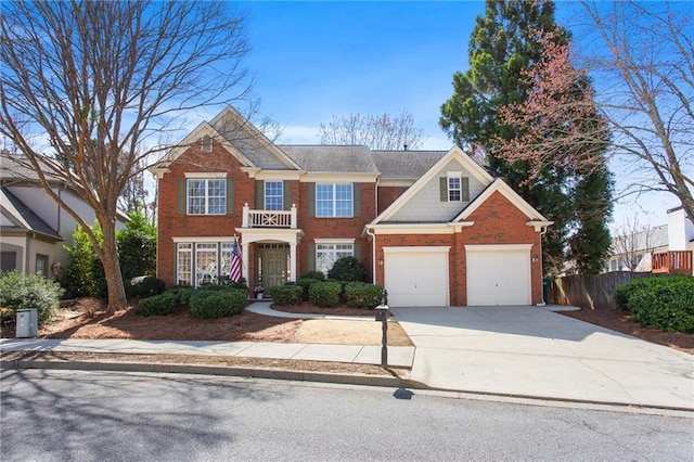 view of front of home with concrete driveway, fence, and brick siding