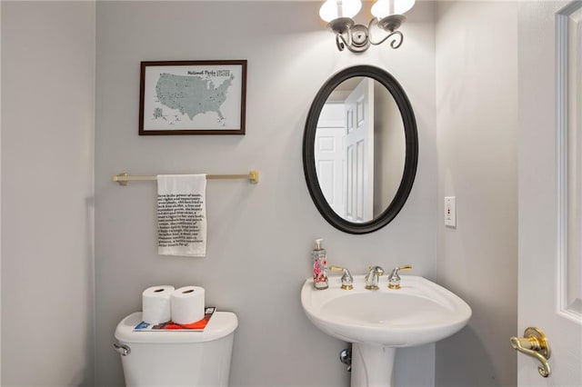 bathroom with toilet and a sink