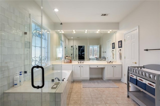 bathroom featuring visible vents, a stall shower, a sink, tile patterned floors, and a bath