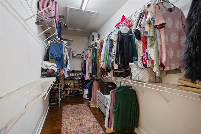 spacious closet with attic access and wood finished floors