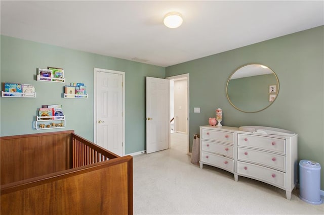 bedroom with baseboards and light carpet