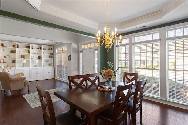 dining room featuring a tray ceiling, an inviting chandelier, dark wood-style floors, and visible vents