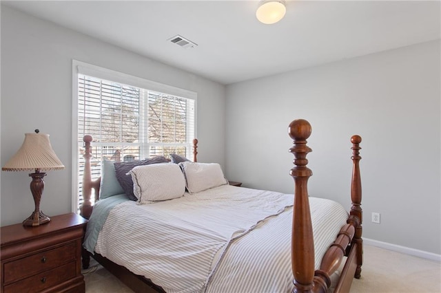 bedroom with light colored carpet, visible vents, and baseboards