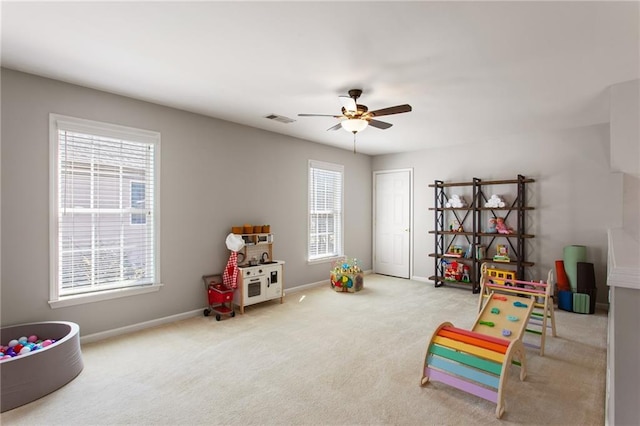 game room featuring carpet, a ceiling fan, visible vents, and baseboards