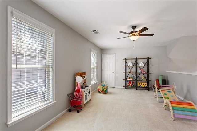 playroom with a wealth of natural light, visible vents, and carpet flooring