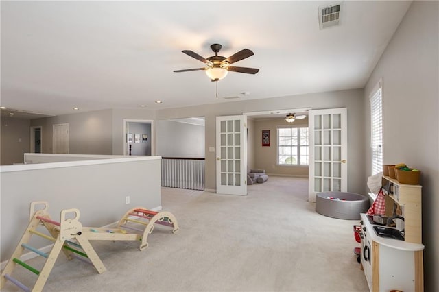 rec room with baseboards, visible vents, carpet floors, ceiling fan, and french doors