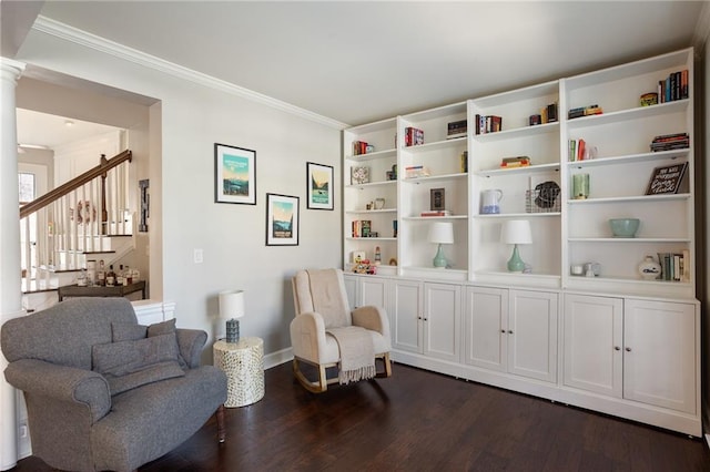 living area featuring stairs, decorative columns, dark wood-style flooring, and crown molding