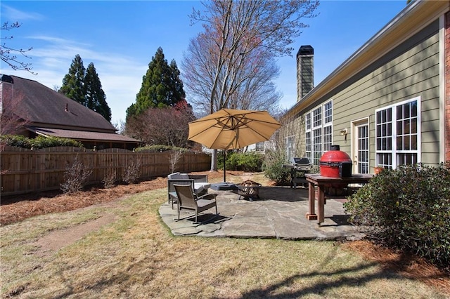 view of yard with a patio, an outdoor fire pit, and fence