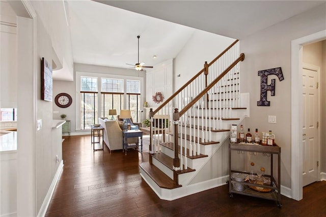 stairs featuring baseboards, ceiling fan, and hardwood / wood-style floors