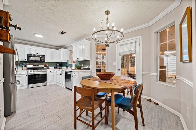 kitchen with white cabinetry, decorative light fixtures, light wood-type flooring, ornamental molding, and appliances with stainless steel finishes