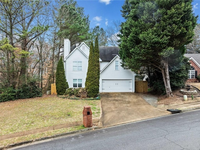 view of front of property with a garage and a front lawn