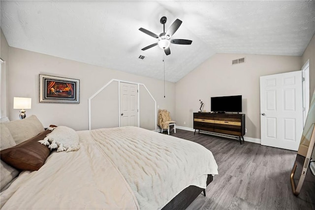 bedroom with ceiling fan, dark hardwood / wood-style flooring, and vaulted ceiling