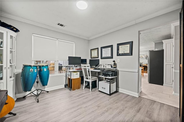 home office featuring crown molding and light hardwood / wood-style floors