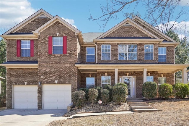 view of front of home with an attached garage, covered porch, concrete driveway, and brick siding