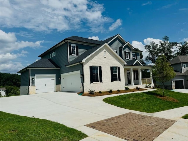 view of front of property featuring a front lawn and a garage