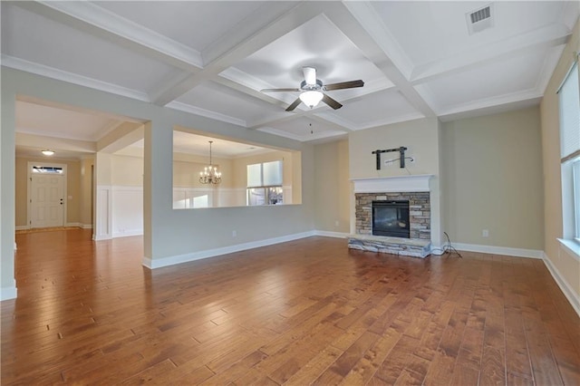 unfurnished living room with ceiling fan with notable chandelier, beam ceiling, and coffered ceiling