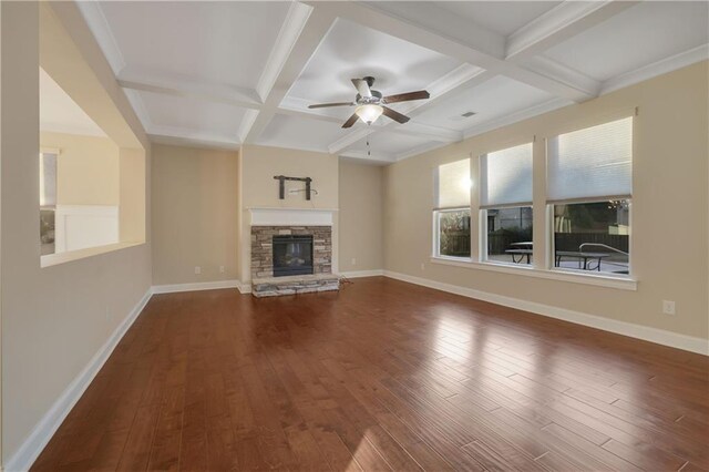 unfurnished living room with a stone fireplace, ceiling fan, beamed ceiling, and coffered ceiling