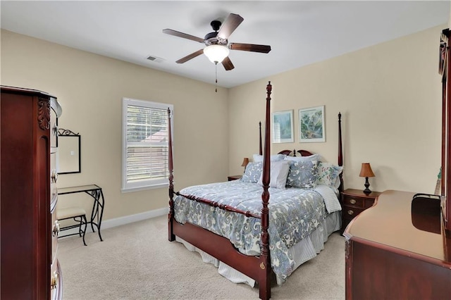 bedroom with ceiling fan and light carpet