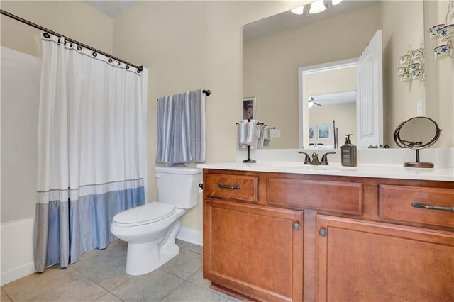 full bathroom with vanity, tile patterned floors, ceiling fan, toilet, and shower / tub combo