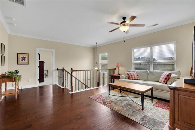 living room featuring crown molding, ceiling fan, and dark wood-type flooring