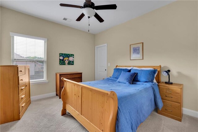 bedroom featuring ceiling fan and light carpet