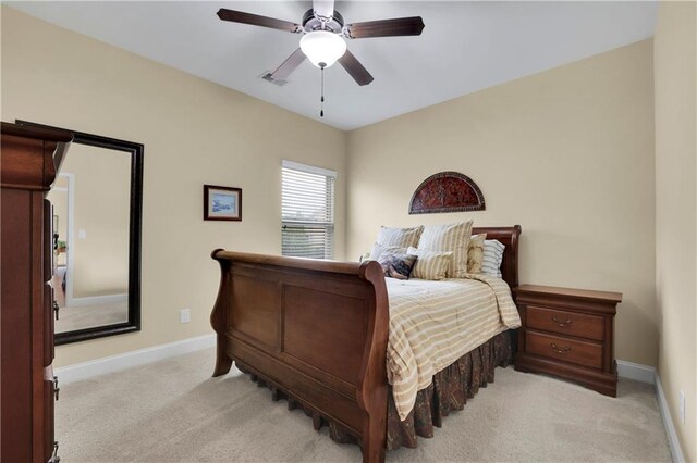 bedroom with ceiling fan and light colored carpet