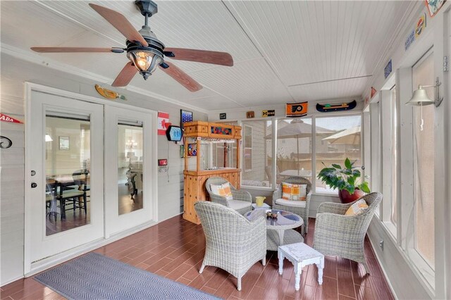 sunroom / solarium with ceiling fan and french doors