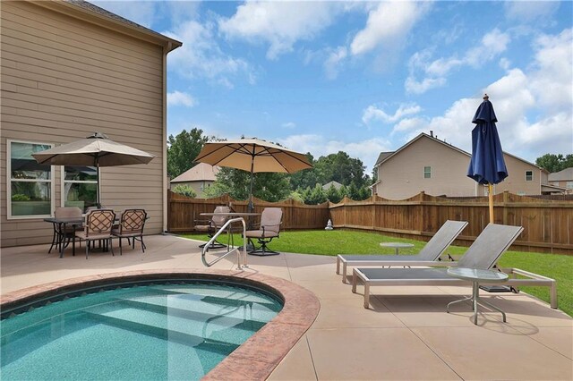 view of swimming pool featuring a patio area and a yard