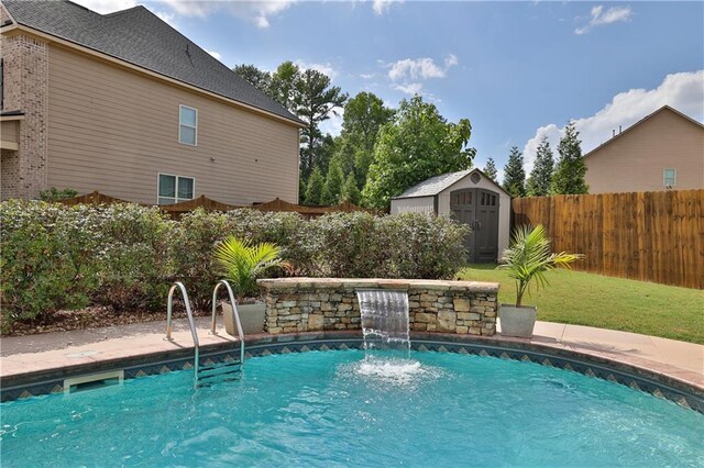 view of swimming pool featuring pool water feature and a shed