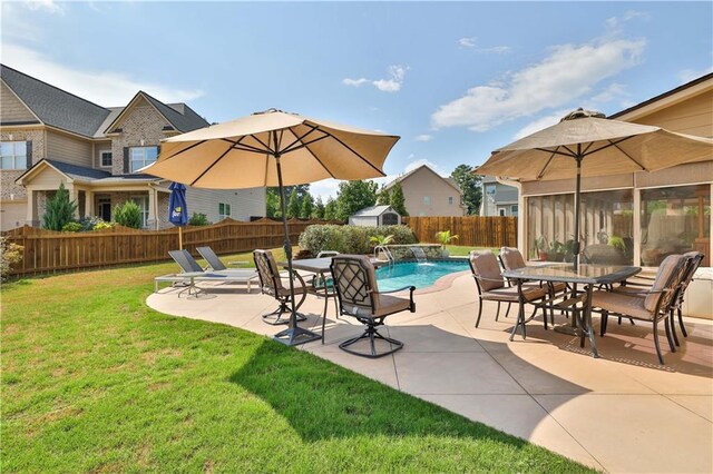 view of swimming pool with a patio area, pool water feature, and a yard