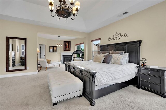 carpeted bedroom with a chandelier