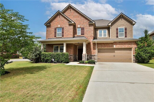 craftsman-style home featuring a front yard and a garage