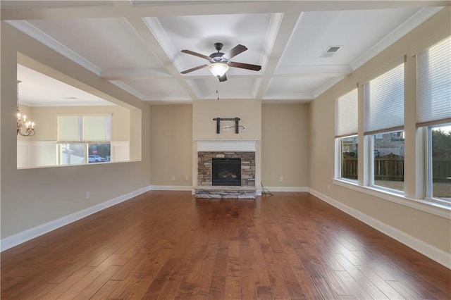 unfurnished living room with beamed ceiling, a stone fireplace, dark hardwood / wood-style flooring, and coffered ceiling