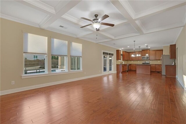 unfurnished living room with coffered ceiling, ceiling fan, crown molding, beamed ceiling, and dark hardwood / wood-style floors