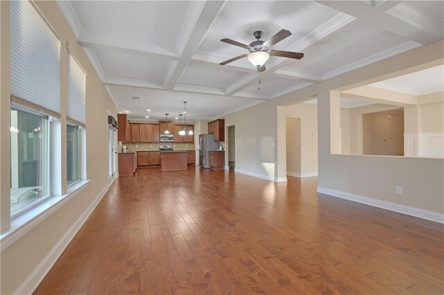 unfurnished living room with ornamental molding, coffered ceiling, ceiling fan, beam ceiling, and hardwood / wood-style flooring