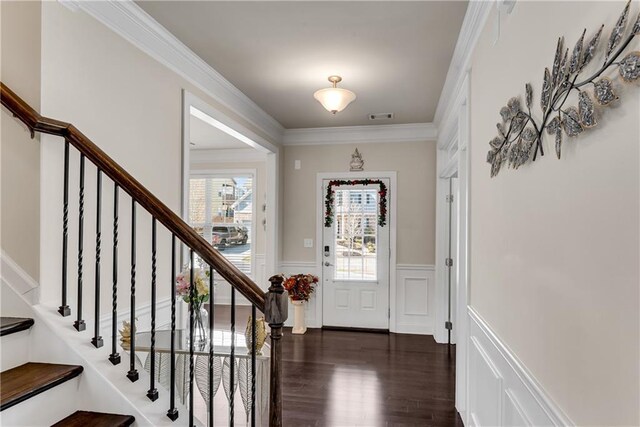 3950 Grandview Manor Dr, Cumming, GA 30028 - foyer entrance featuring wainscoting, visible vents, stairs, crown molding, and dark wood-type flooring