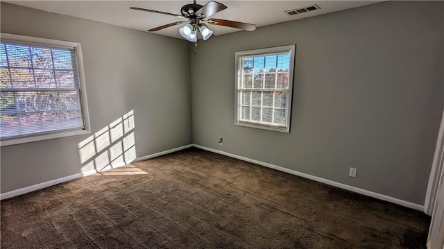 unfurnished room featuring ceiling fan and dark carpet