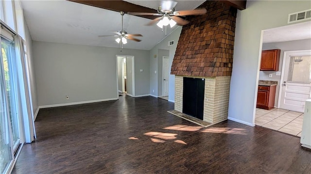 unfurnished living room with ceiling fan, a brick fireplace, high vaulted ceiling, beamed ceiling, and wood-type flooring