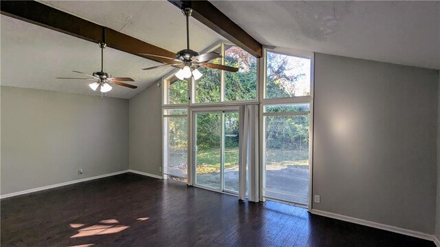 empty room with vaulted ceiling with beams, ceiling fan, dark hardwood / wood-style flooring, and a wealth of natural light