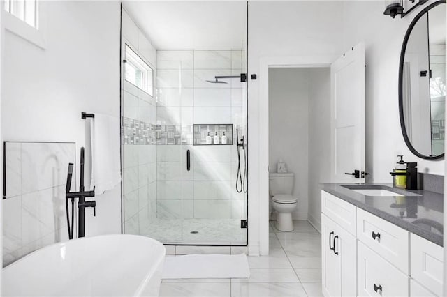 full bathroom featuring vanity, separate shower and tub, and toilet