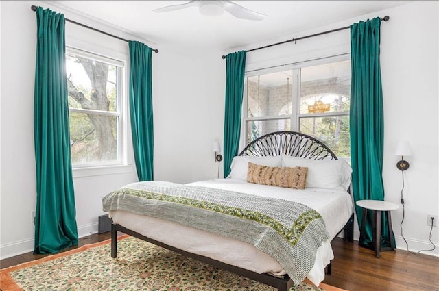 bedroom with dark wood-type flooring and ceiling fan