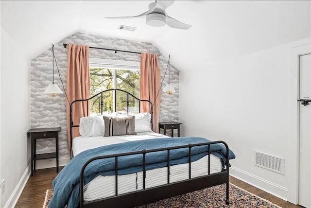 bedroom featuring dark hardwood / wood-style flooring, lofted ceiling, and ceiling fan