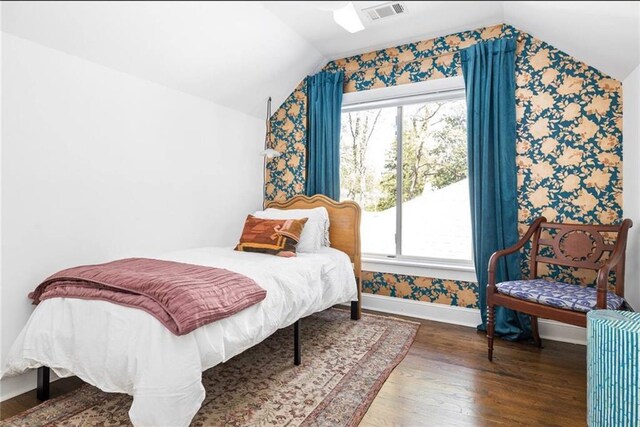 bedroom featuring lofted ceiling and hardwood / wood-style floors