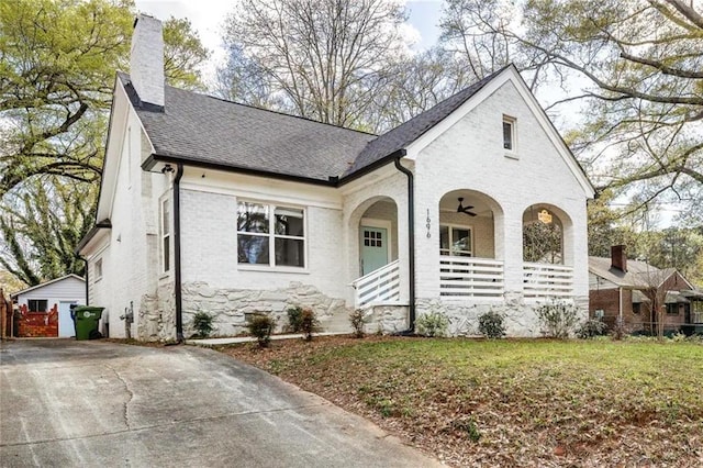 french country inspired facade featuring a porch and a front lawn