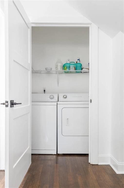 washroom featuring washing machine and clothes dryer and dark hardwood / wood-style floors