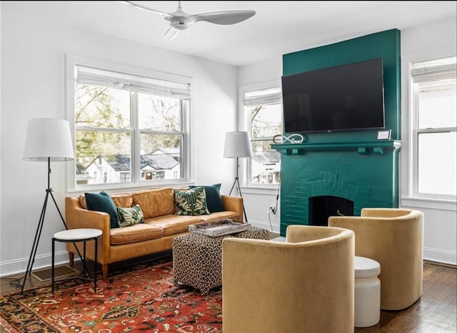 interior space with hardwood / wood-style floors, a fireplace, and ceiling fan