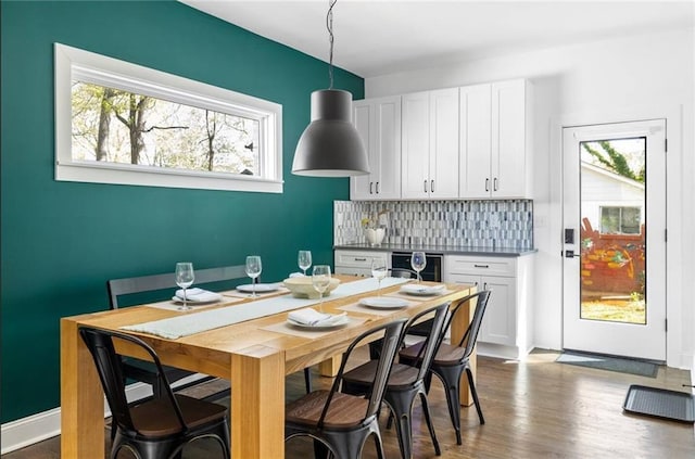 dining area featuring a healthy amount of sunlight and hardwood / wood-style floors