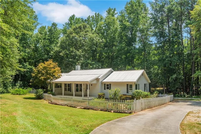 ranch-style house with covered porch and a front lawn